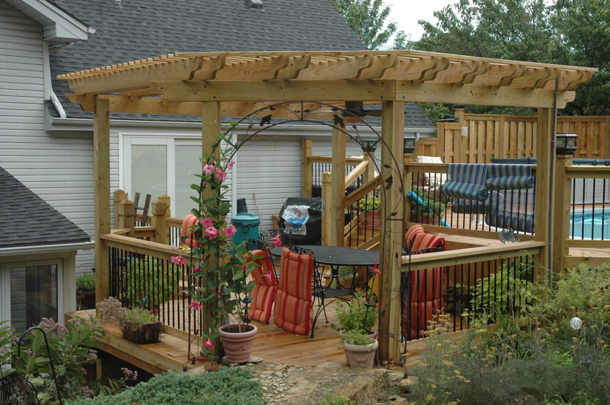 A custom-built wooden deck with a pergola and outdoor living space by Holm Remodeling Company in Kansas City, KS.