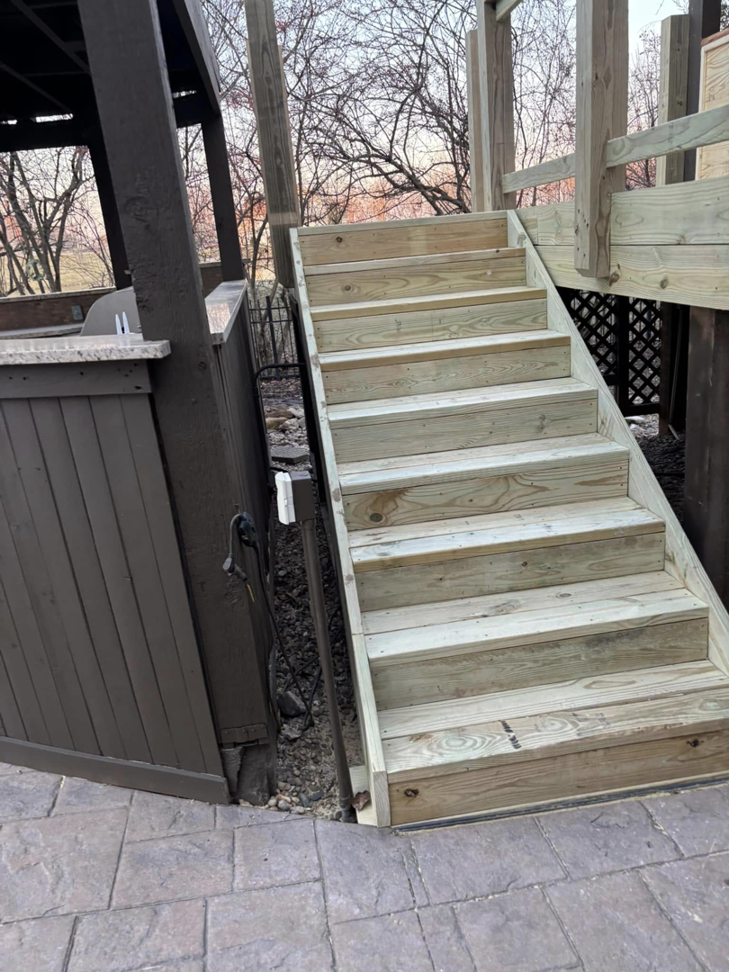 Professional installation of a new wooden deck staircase by Top Gunn Family Construction in Truxton, MO.
