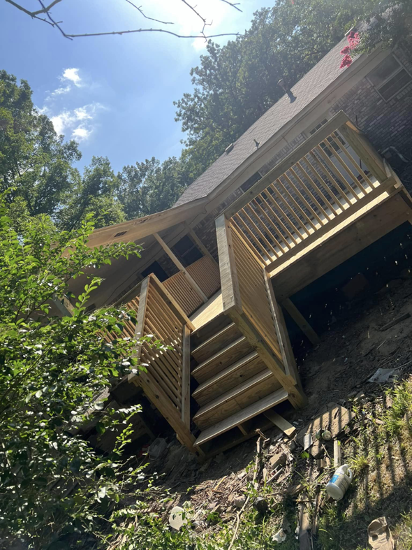 A view of the newly constructed wooden deck stairs and railing from below, built by JD Handyman service LLC in Miami, FL.