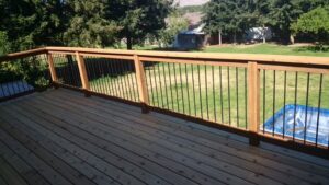 A newly built wooden deck featuring modern metal railings, constructed by TPF Services in Yakima, WA.