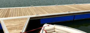 A well-maintained wooden dock with a boat tied, serviced by Walks On Water, Inc in Clear Lake, MN