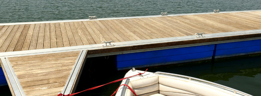 A well-maintained wooden dock with a boat tied, serviced by Walks On Water, Inc in Clear Lake, MN