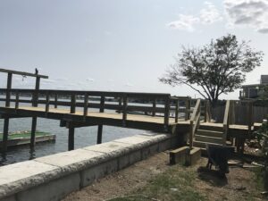 A newly constructed wooden dock and pier extending over the water by Solimini Excavation and Utility in Freetown, MA