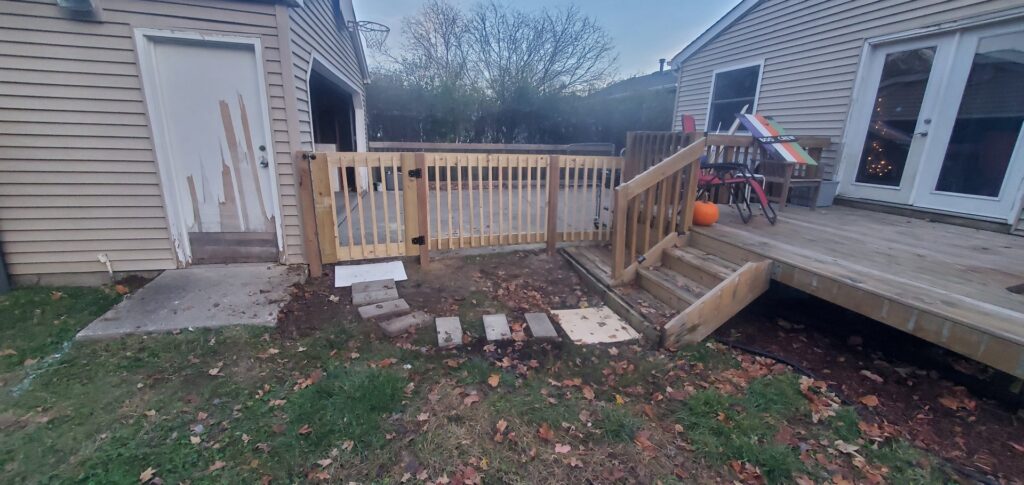 Newly installed wooden fence and deck steps by Justin-case Repairs in Ankeny, IA.