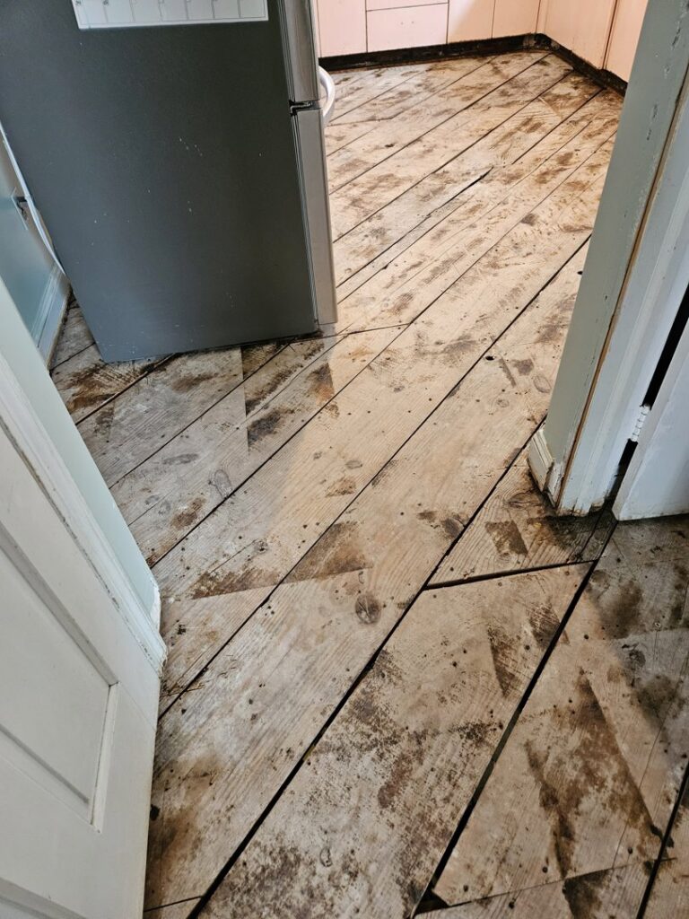Close-up of wooden floorboards being repaired or installed, a handyman service by AA Asbestos Abatement, LLC in Portland, CT.