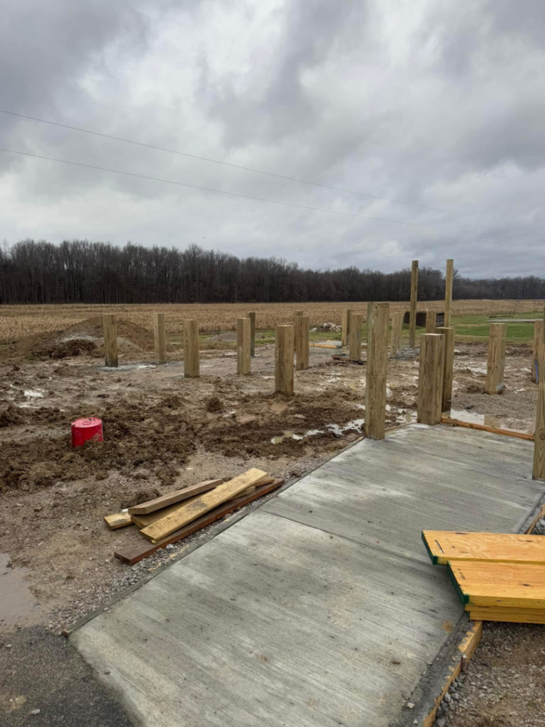 Wooden foundation posts and a concrete slab for a new construction project by Phillip's Home Repair in Owensboro, KY