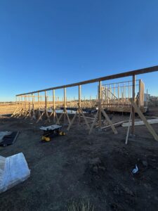 Wooden framing for a new structure under construction by Blue Collar Service Pros in Aurora, CO.