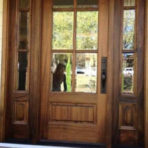 A newly installed wooden front door with glass panels and sidelights by The Window & Door Gallery in Elizabethtown, KY.