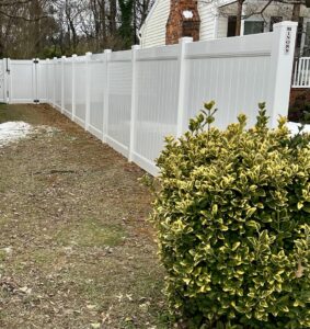 A newly built wooden lattice screen covering outdoor utility units by Minors Fences in Ashland, VA.