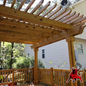 A newly constructed wooden pergola over a deck by Bull City Painting & Roofing in Durham, NC