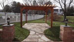 A custom wooden pergola over a flagstone patio with stone pillars by Rescue Landscaping and Outdoor Living in St. Louis, MO