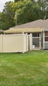 Construction of a new wooden pergola frame next to a house by CJP Construction handyman services in Pierce, NE.