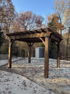 A newly installed wooden pergola in a backyard by Profix Home Repair in Jonesboro, AR.