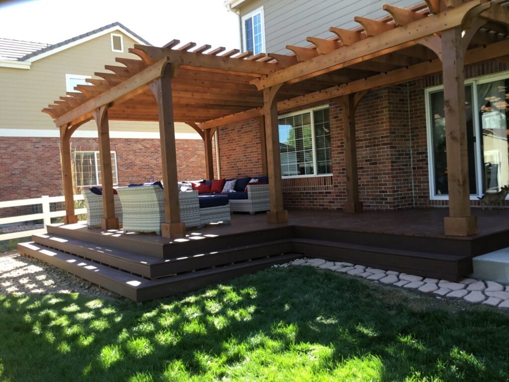A custom-built wooden pergola providing shade over a deck with outdoor seating by Lnk Deck & Remodels, LLC in Aurora, CO.
