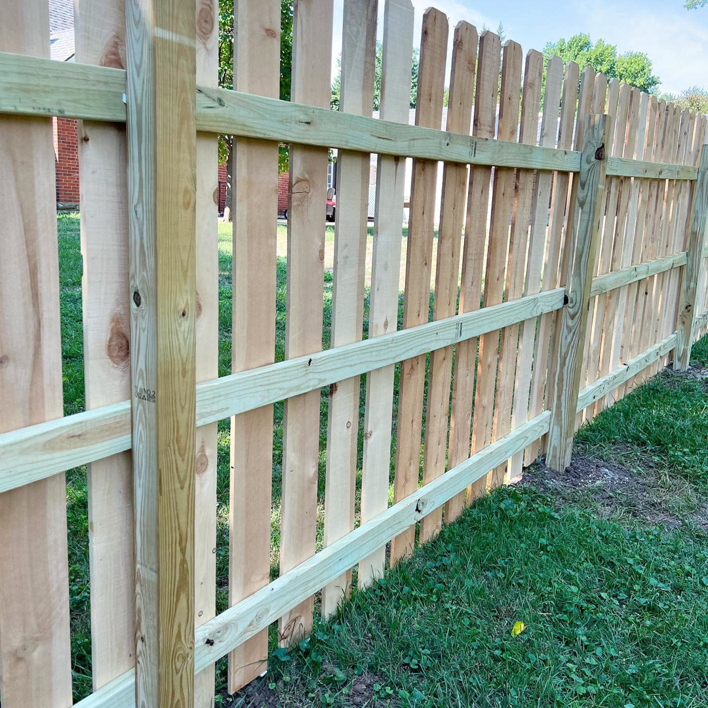 Detailed view of a newly constructed wooden picket fence by Cutting Edge Contracting and Handyman in Minneapolis, MN.
