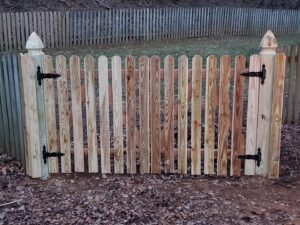 A newly installed wooden picket fence gate by Quality Fence & Deck Co. in Frederick, MD.