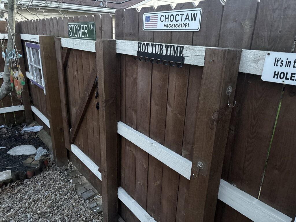 A new wooden picket fence and gate installed along the side of a house by Ofandiski Fence Co. Inc in Lorain, OH.