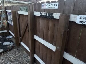 A new wooden picket fence and gate installed along the side of a house by Ofandiski Fence Co. Inc in Lorain, OH.