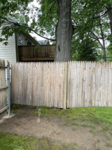 A newly installed wooden picket fence by Digby Handyman Services LLC in Cranston, RI.