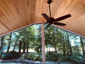 Stylish wooden plank ceiling and ceiling fan in a screened porch by Creative Renovations, Inc. in Cary, NC.