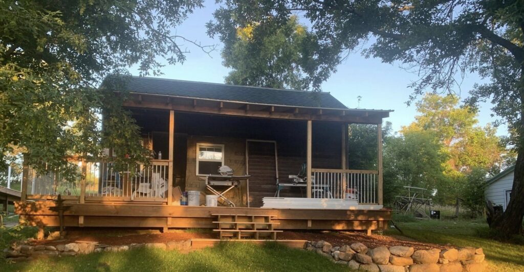 Construction of a new wooden porch and deck on a small cabin by Vander Wal Contracting, LLC in Bismarck, ND