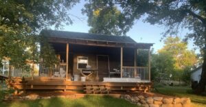 Construction of a new wooden porch and deck on a small cabin by Vander Wal Contracting, LLC in Bismarck, ND