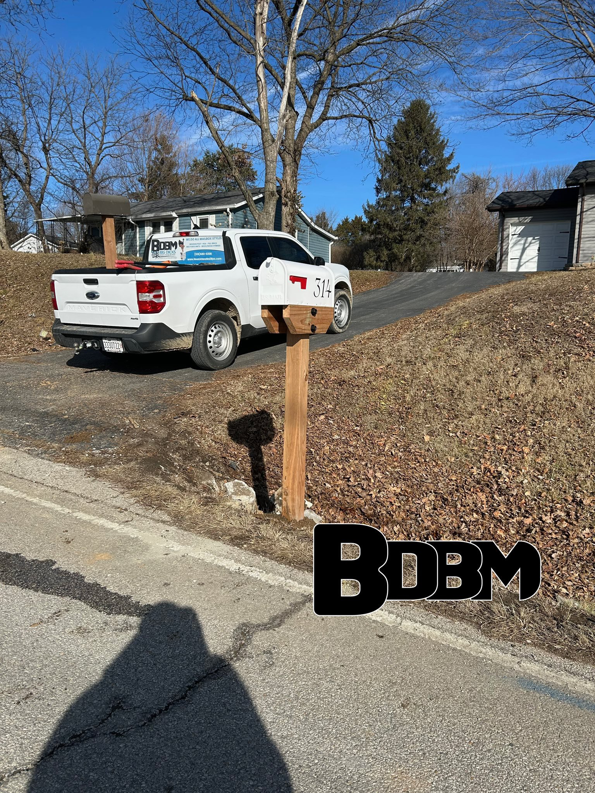 A new mailbox with a wooden post and house number 514 installed by Big Dicks Brick Mailboxes in St. Louis, MO.
