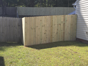Professional installation of a new wooden privacy fence and gate by S&L Decking and Fencing in Charlotte, NC.