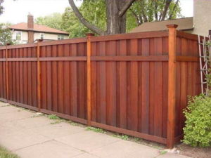 A well-maintained wooden privacy fence installed by A/M Fence, a handyman service in Norman, OK