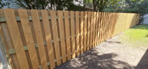 A newly installed wooden privacy fence providing security and seclusion by Fence & Deck Connection, Inc. in Savannah, GA.