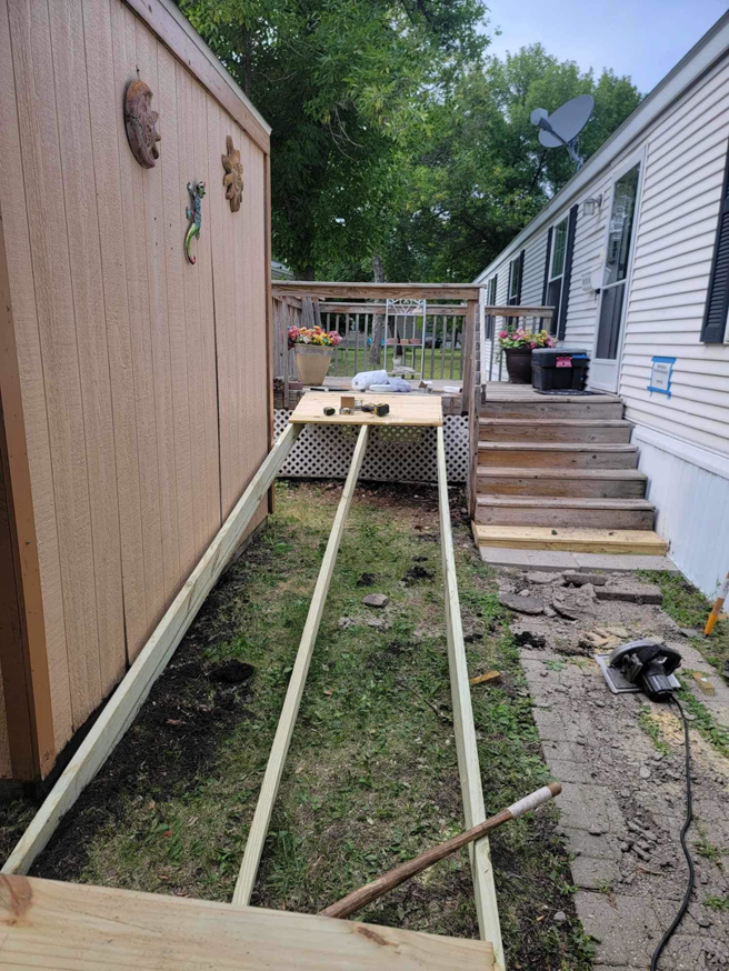 Wooden ramp framing under construction with a circular saw nearby, a service provided by Becker Services ND in West Fargo, ND.