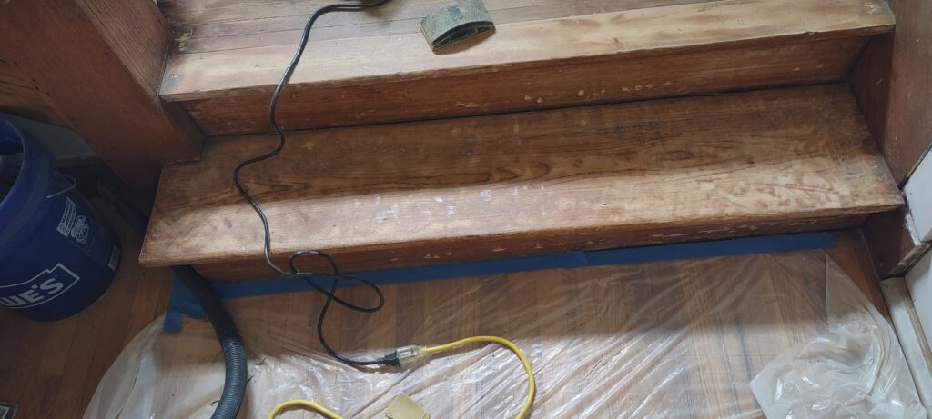 Wooden stairs taped off and prepped for refinishing work by Handyashby in Saint Joseph, MO.