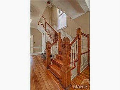 A beautifully crafted wooden staircase and hallway, showcasing remodeling work by Major League Handyman and Remodeling in St. Louis, MO.