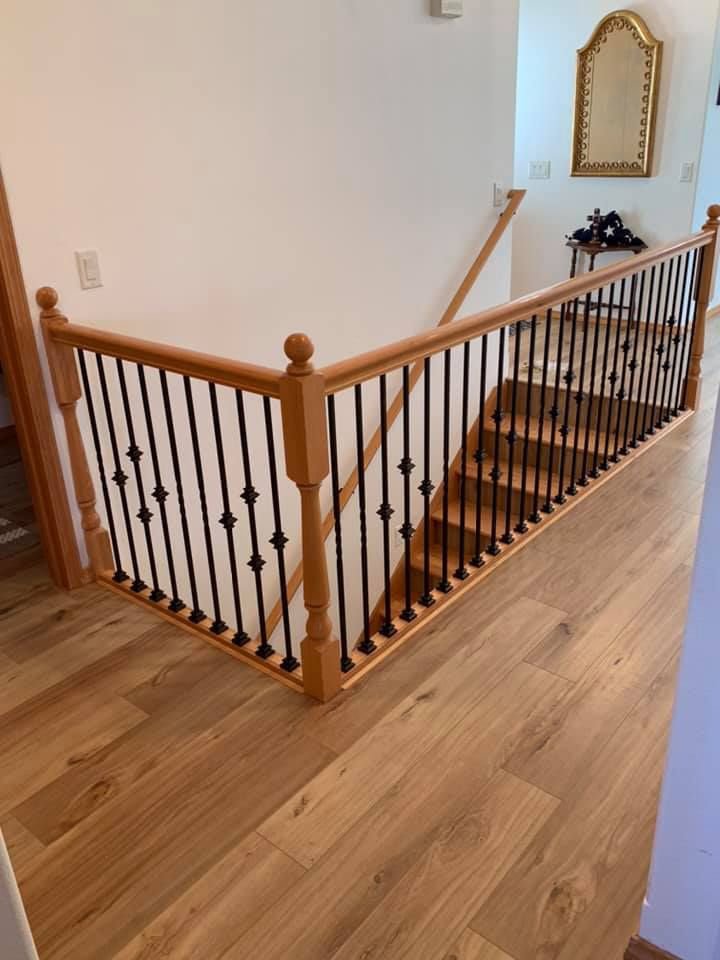 A newly installed wooden staircase with black metal balusters by Myers & Myers Construction in Spokane, WA.