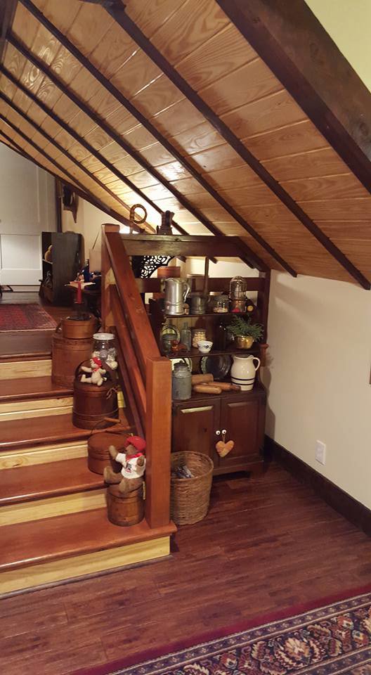 A beautifully renovated wooden staircase and railing in a home by Pro Renovations Savannah, GA.