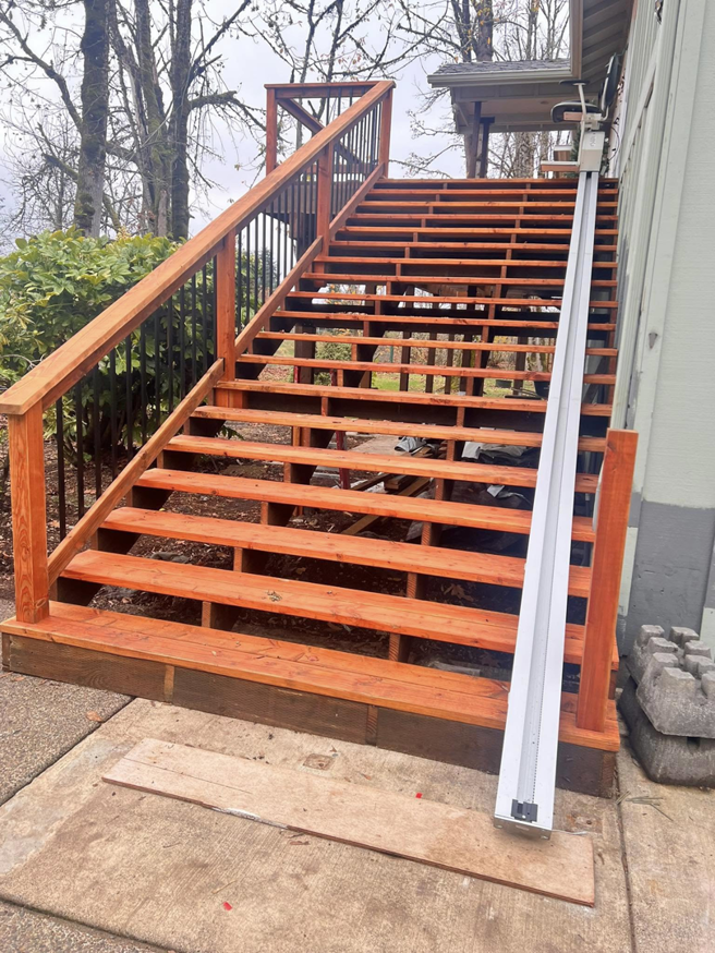 A wooden staircase under construction, showing ongoing handyman work by One Up construction llc in Springfield, OR.