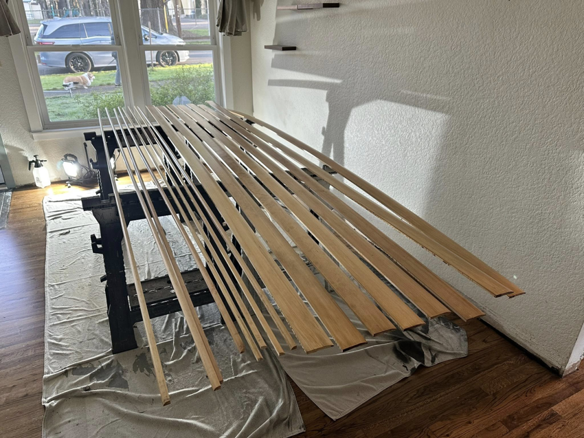 Wooden trim pieces laid out on sawhorses, ready for custom finishing by Valleys Finest Custom Finishes LLC in Salem, OR.