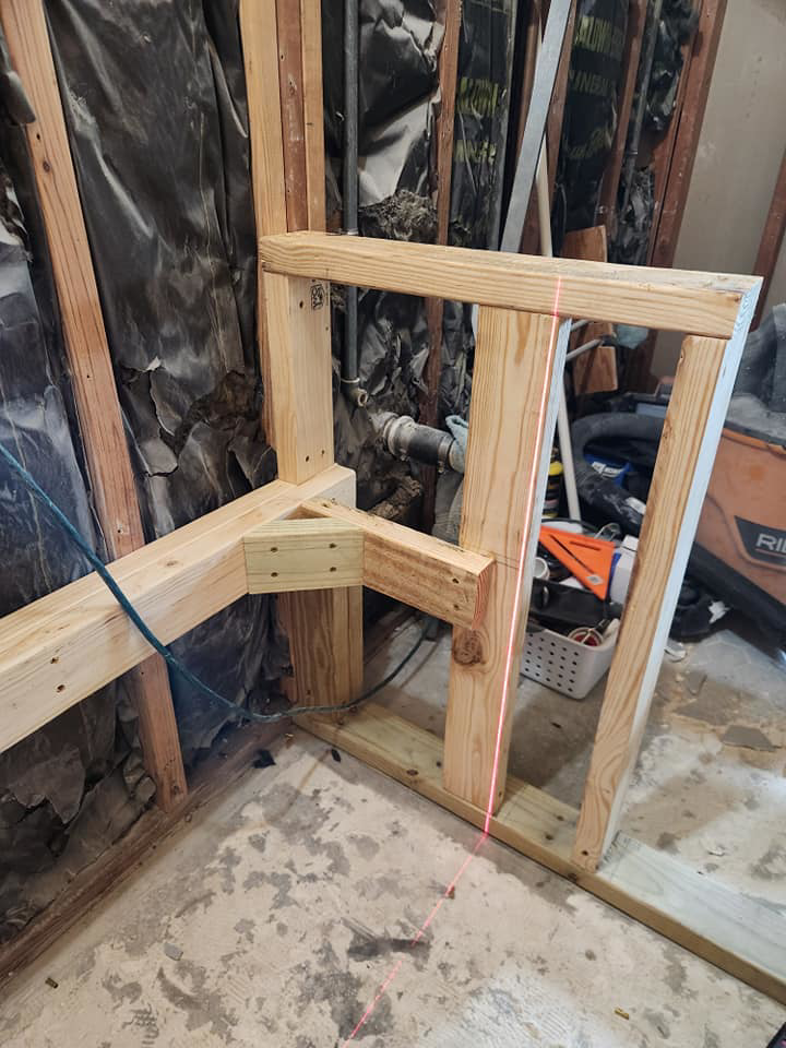 New wooden wall framing under construction with a laser level by AJAC Restore&Construct LLC in Houma, LA.