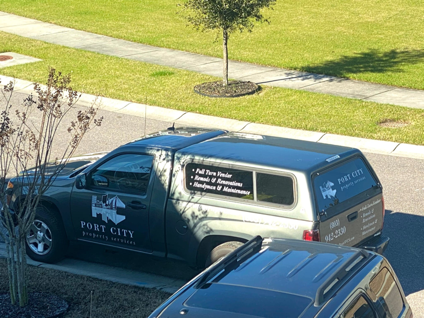 A Port City Maintenance work truck with 'Handyman & Maintenance' services listed on the side, parked in Summerville, SC.