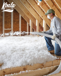 A Koala Insulation worker blowing new insulation into an attic in Baton Rouge, LA.