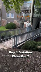A Midwest Removal worker in a hazmat suit performing a bug infestation clean out service in Omaha, NE.