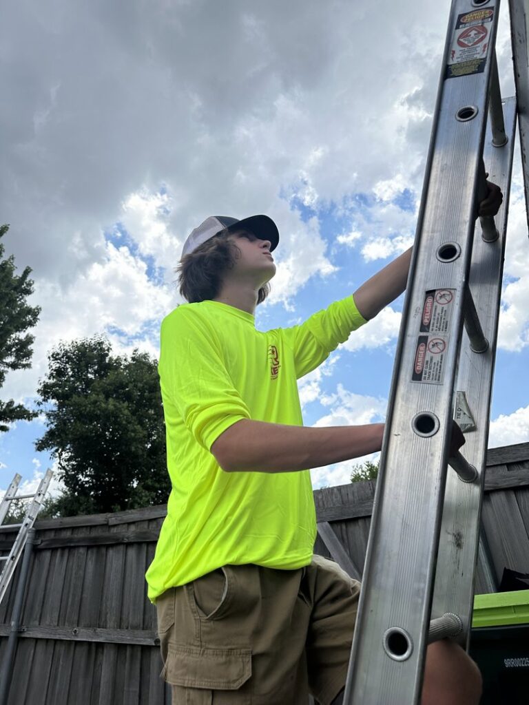A Riker Home Services worker climbing a ladder for a roofing inspection or repair in Plano, TX