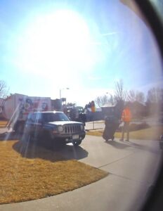 A worker collecting a trash can near an Abe's Trash Service, Inc. truck in Omaha, NE.