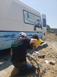 A worker handling equipment on a service truck for a job by S & L Water Solutions in Hagerstown, MD.