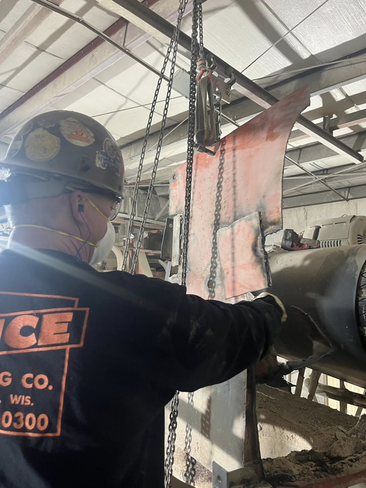 A worker from The Price Erecting Co. performing industrial equipment repair in Milwaukee, WI.