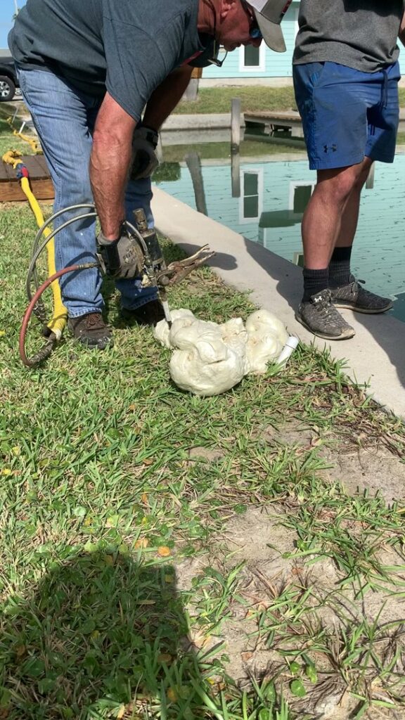 A worker injecting foam for concrete repair services by Complete Foundation Repairs in Corpus Christi, TX.