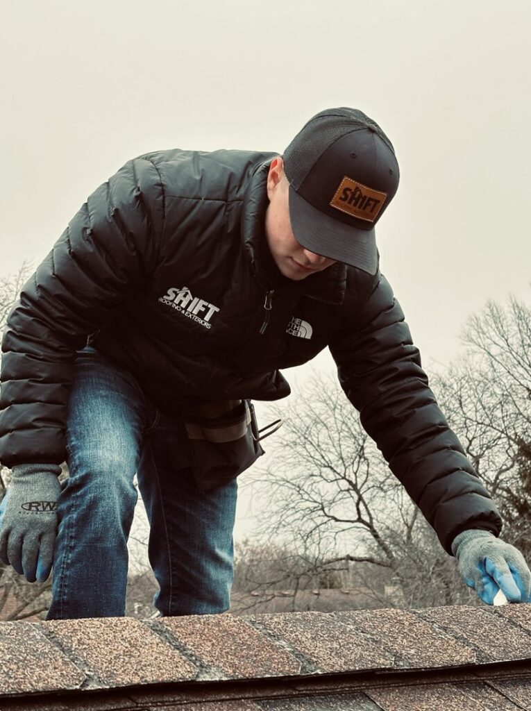 A SHIFT Roofing & Exteriors worker inspecting a residential roof in Gahanna, OH