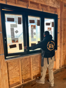 A worker installing or adjusting a new window for Begley Development LLC in Kingsport, TN