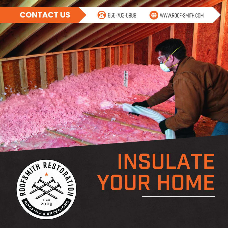 A worker installing pink attic insulation in a home for Roofsmith Restoration in Nashville, TN.