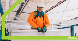 A worker installing insulation in a ceiling on a lift for Powers Insulation in Colorado Springs, CO.